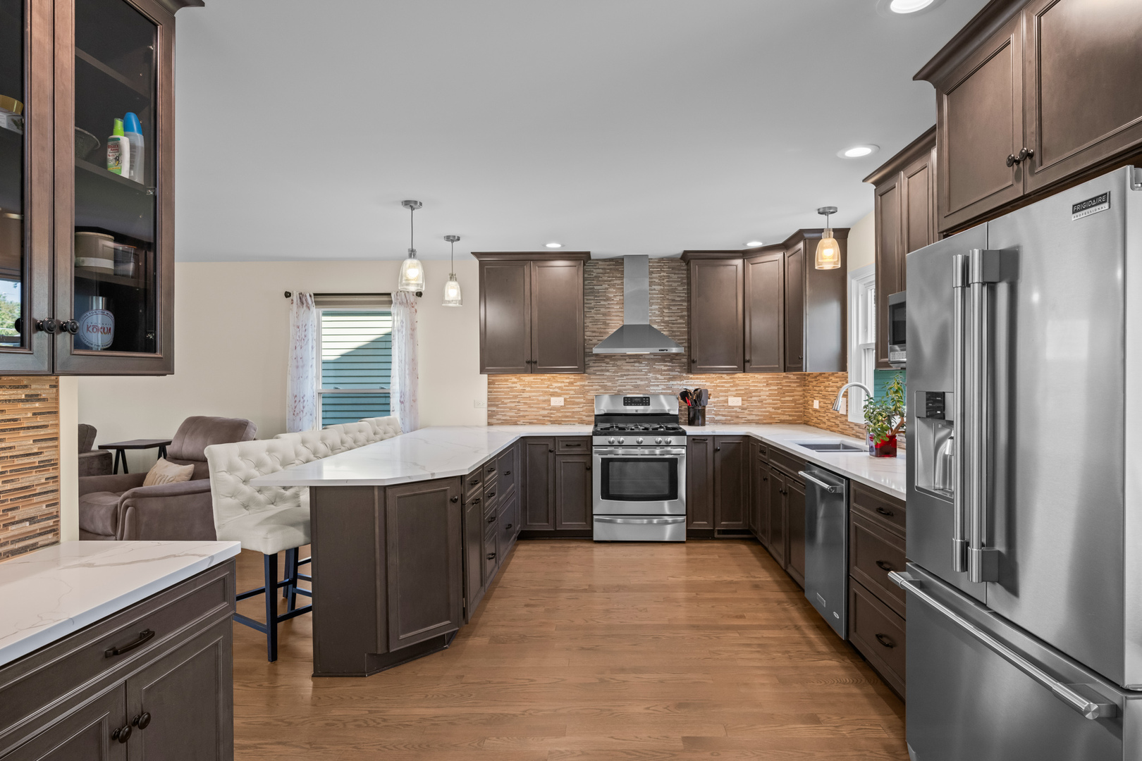 S579 Robbins Street Winfield, IL 60190 - Photo 9 of 36 a large kitchen with stainless steel appliances kitchen island granite countertop a stove refrigerator and cabinets