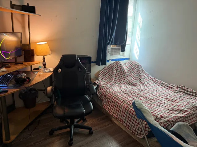 a bedroom with a bed and a window