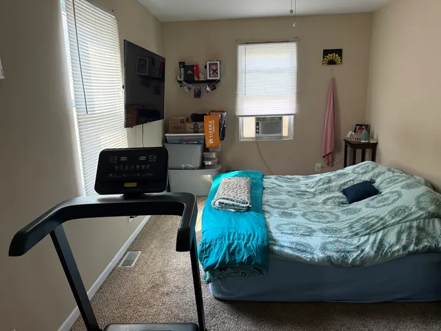 a bedroom with bed and window