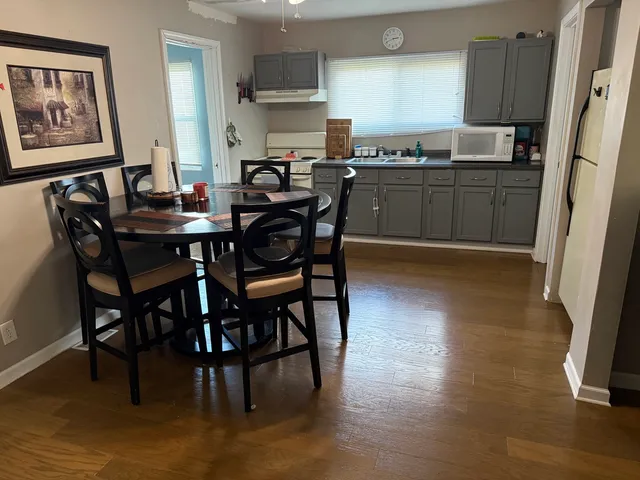 a kitchen with stainless steel appliances wooden floors and wooden cabinets