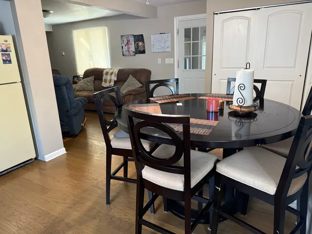 a view of a dining room with furniture and a window