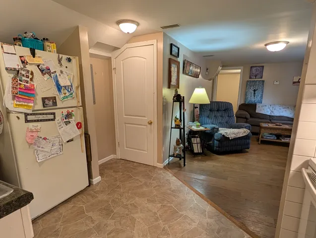 a view of a livingroom with furniture and a fan