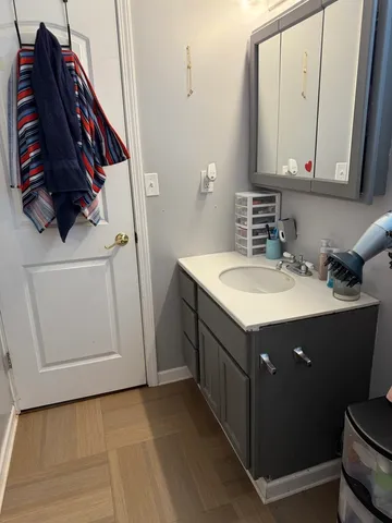 a bathroom with a sink vanity and mirror