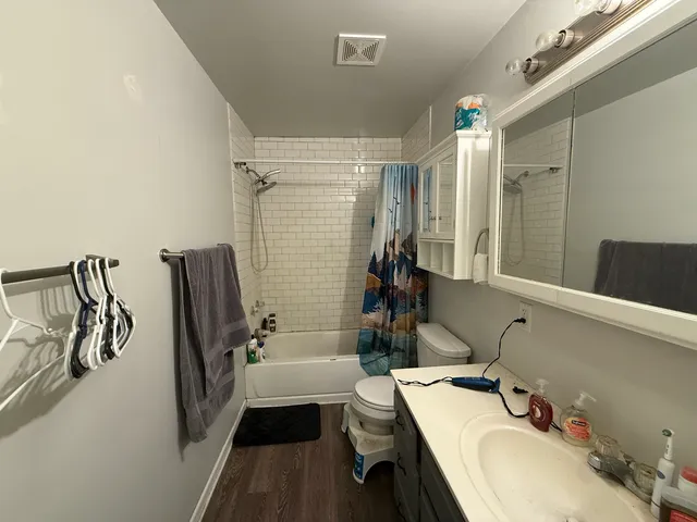 a bathroom with a tub sink and mirror