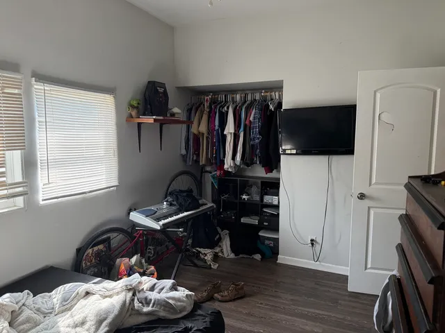 a bedroom with bed and a window