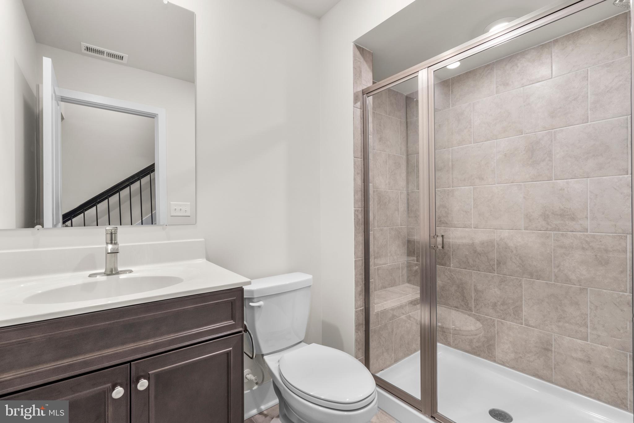 1826 Parham Way Windsor Mill, MD 21244 - Photo 33 of 37 a bathroom with a sink a toilet and shower