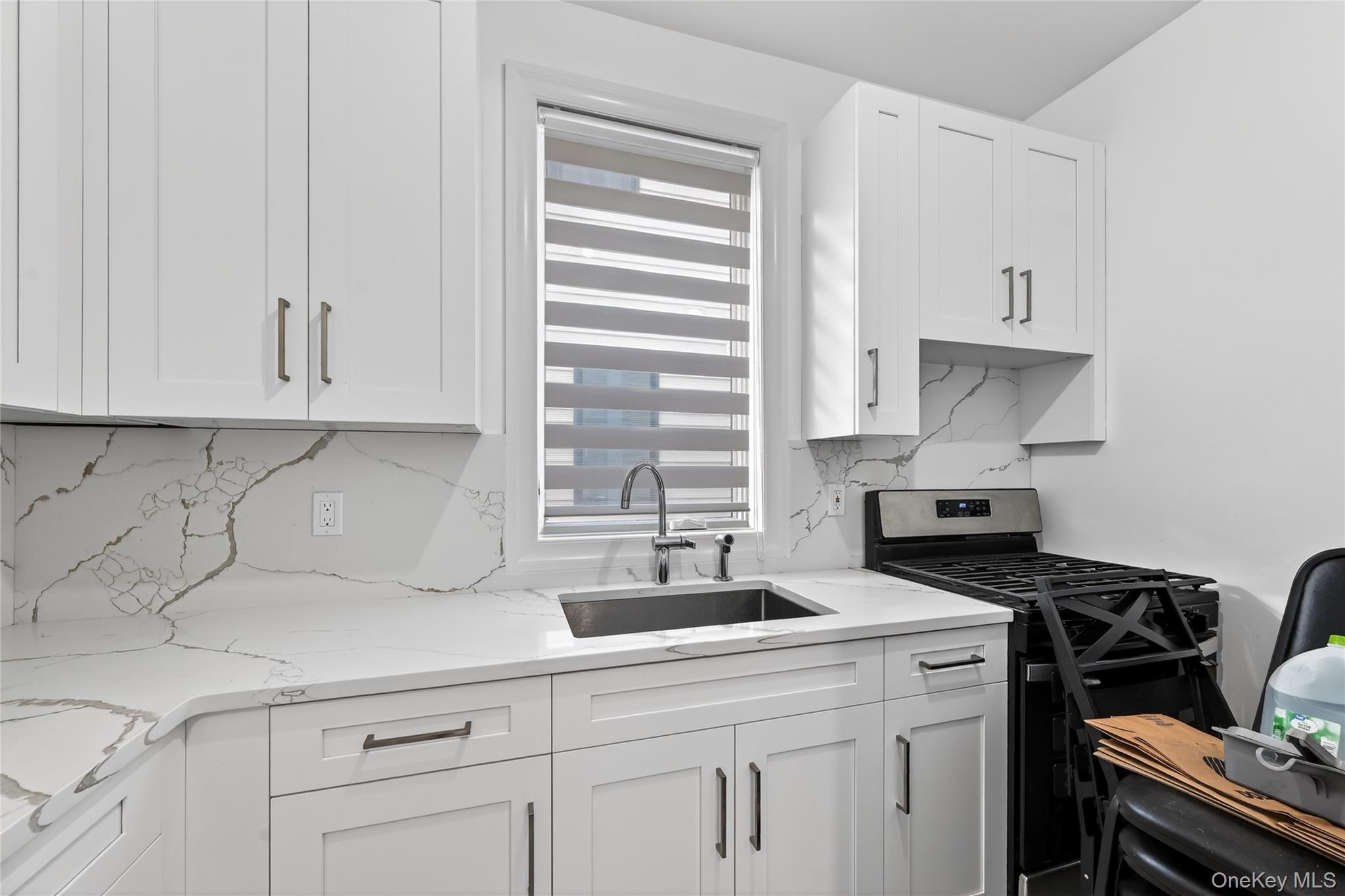 27 Ellish Parkway, Unit 203 Spring Valley, NY 10977 - Photo 15 of 47 a kitchen with stainless steel appliances a sink stove and cabinets