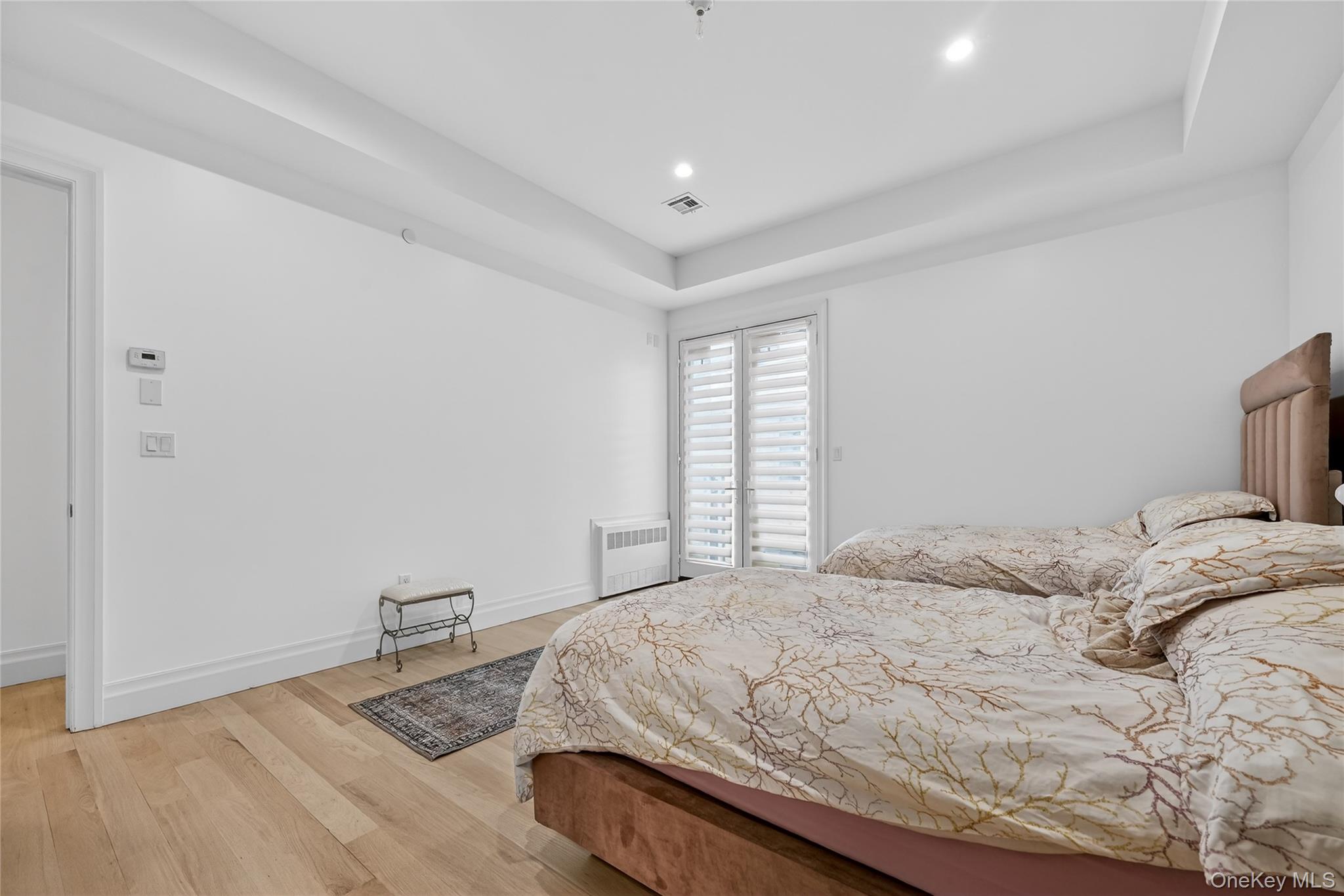 27 Ellish Parkway, Unit 203 Spring Valley, NY 10977 - Photo 31 of 47 a bedroom with a bed and wooden floor