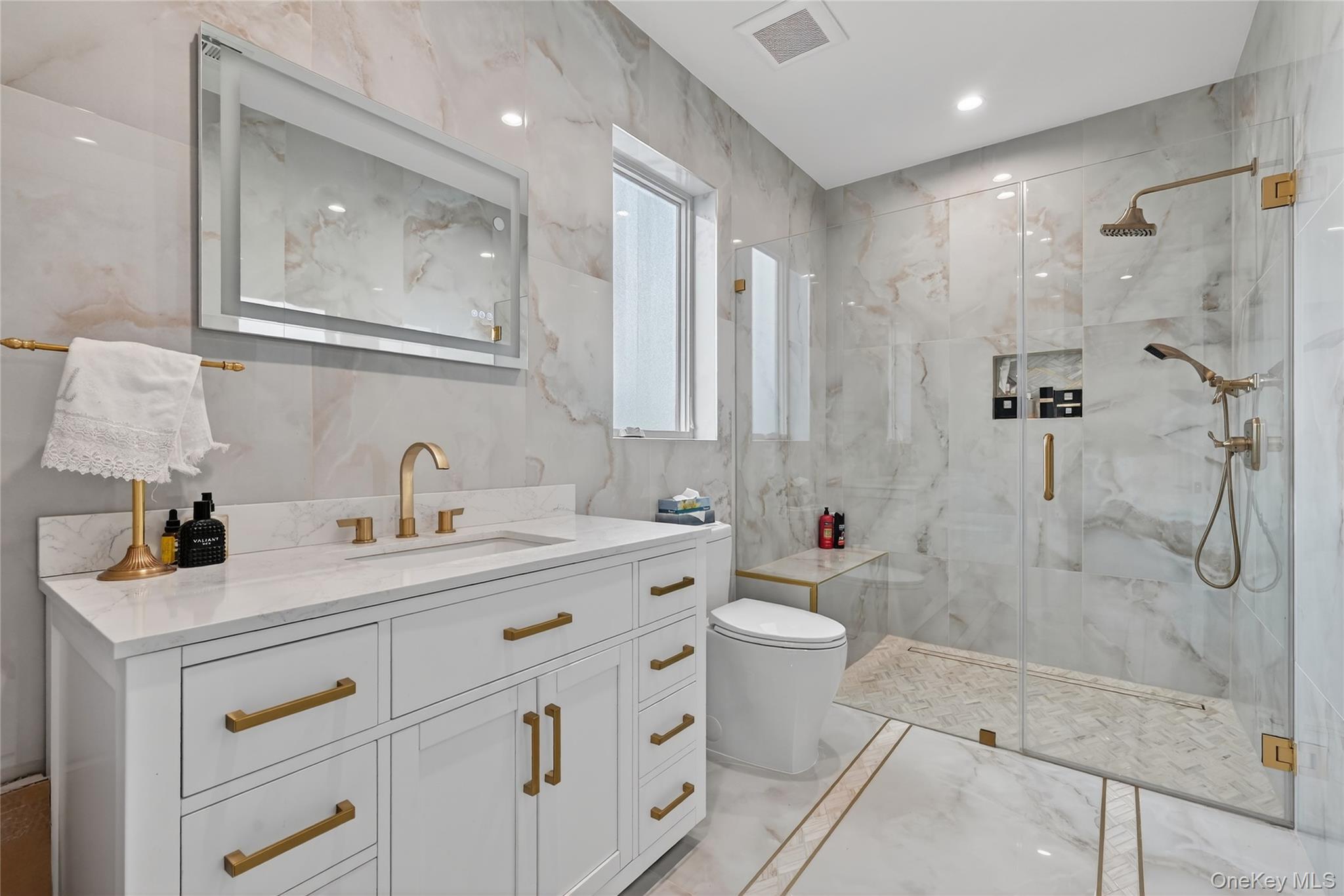 27 Ellish Parkway, Unit 203 Spring Valley, NY 10977 - Photo 34 of 47 a bathroom with a double vanity sink toilet mirror and shower