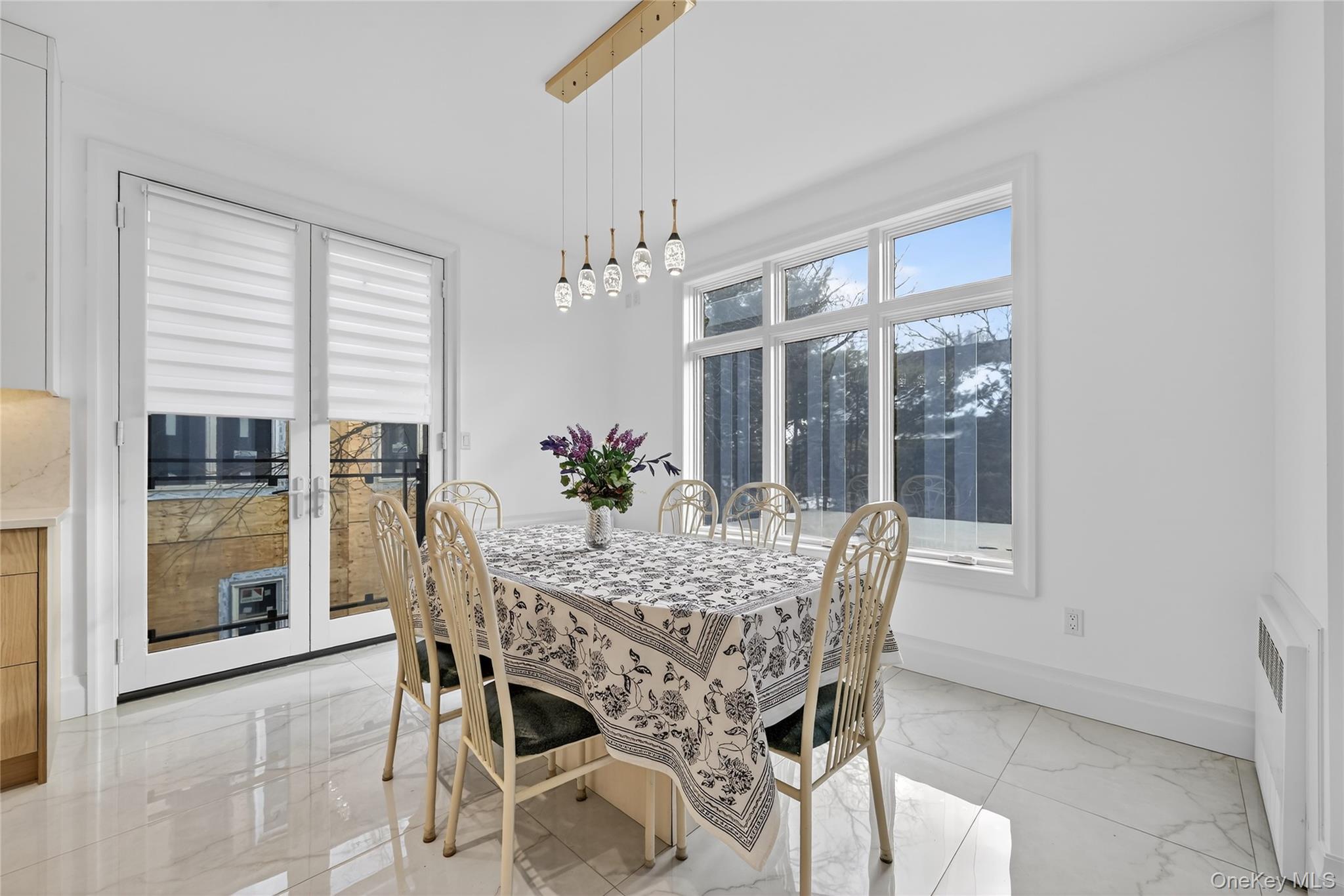 27 Ellish Parkway, Unit 203 Spring Valley, NY 10977 - Photo 9 of 47 a dining room with furniture window and wooden floor