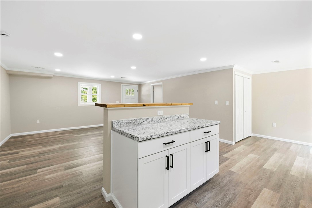 418 Old River Road Pelzer, SC 29669 - Photo 29 of 29 Functional kitchen island with granite counters defines a bright, open floorplan.