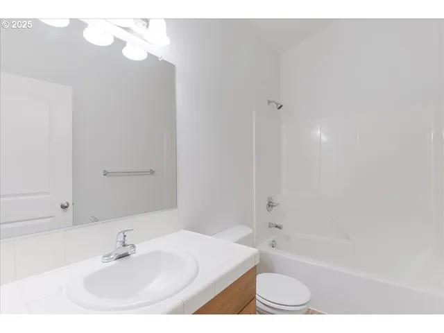 a living room with furniture and a baby crib