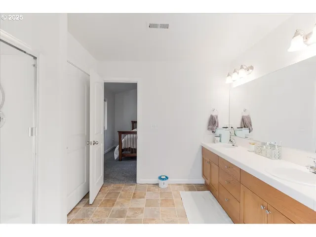 a view of walk in closet with clothes