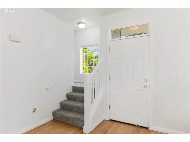 a view of an entryway with wooden floor