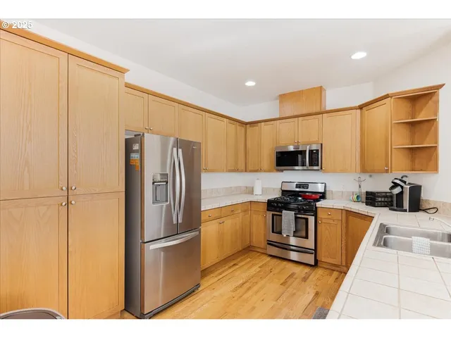a kitchen with stainless steel appliances a refrigerator and a stove