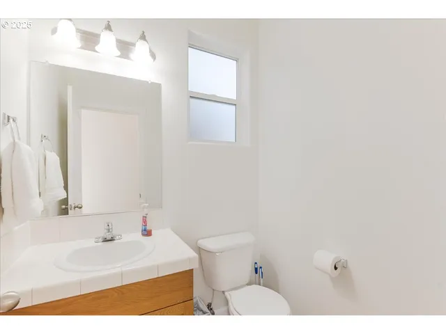 a bathroom with a sink a toilet and mirror