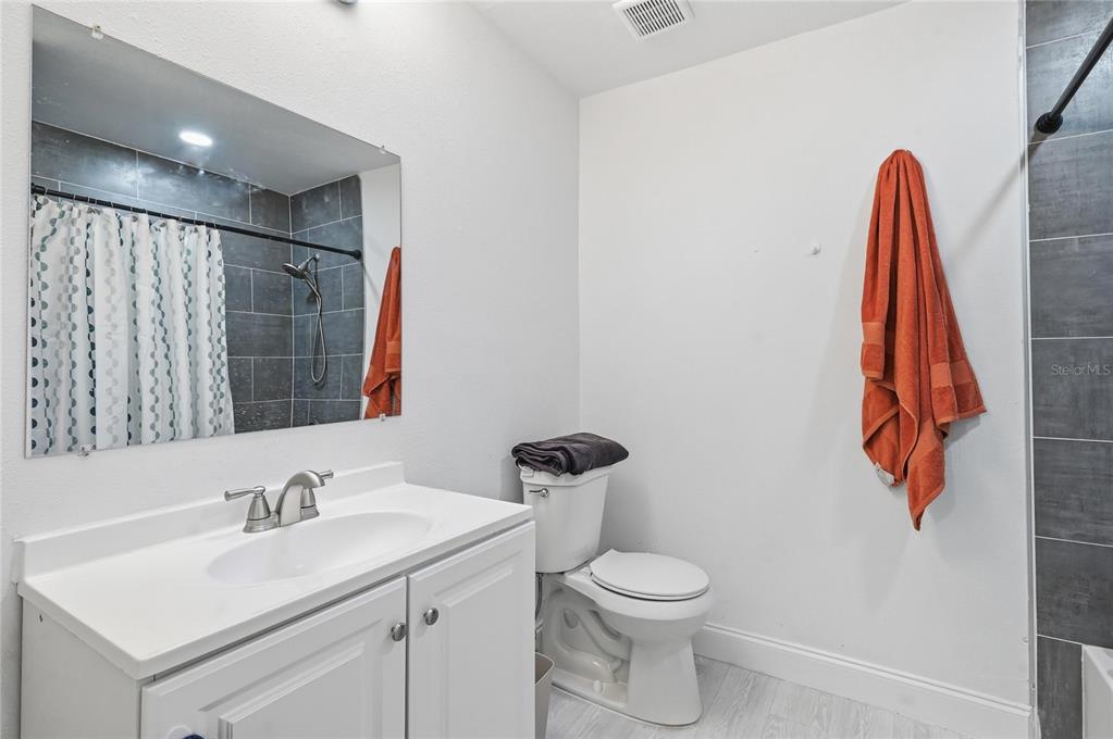 1946 Strathaven Road Winter Park, FL 32792 - Photo 16 of 37 a bathroom with a sink vanity and a toilet