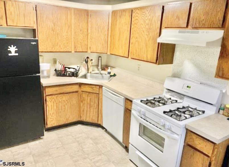 118 Sussex Place, Unit 118 Galloway Township, NJ 08205 - Photo 4 of 8 a kitchen with a sink a stove and cabinets