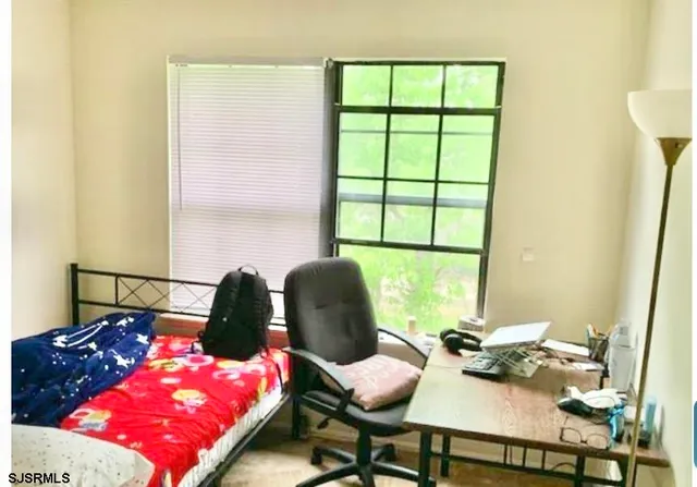 a bedroom with a bed and window
