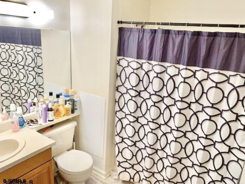 118 Sussex Place, Unit 118 Galloway Township, NJ 08205 - Photo 7 of 8 a bathroom with a toilet and a sink