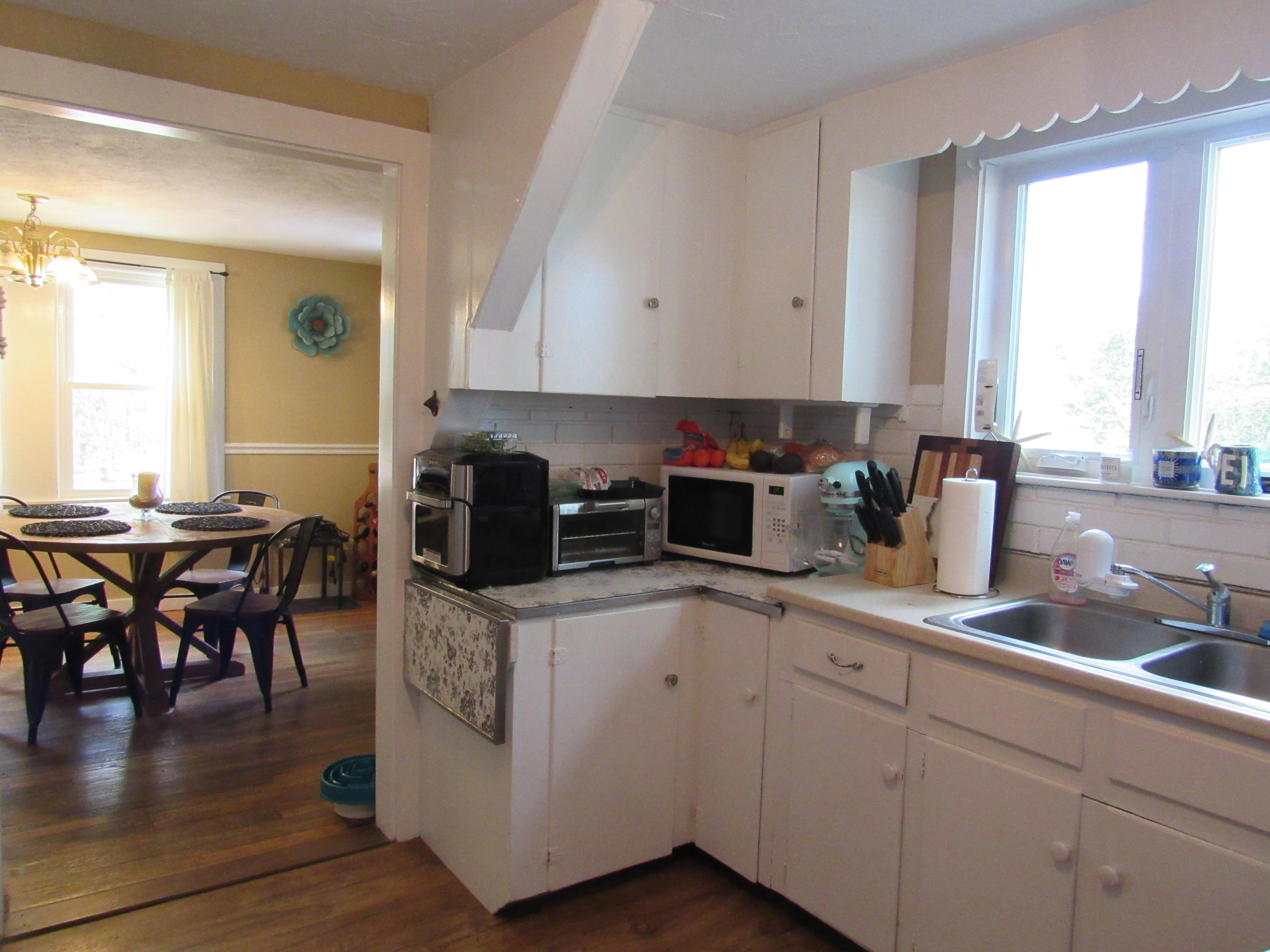 69 Nightingale Road Buzzards Bay, MA 02532 - Photo 4 of 21 a kitchen with stainless steel appliances granite countertop a sink a stove a dining table and chairs