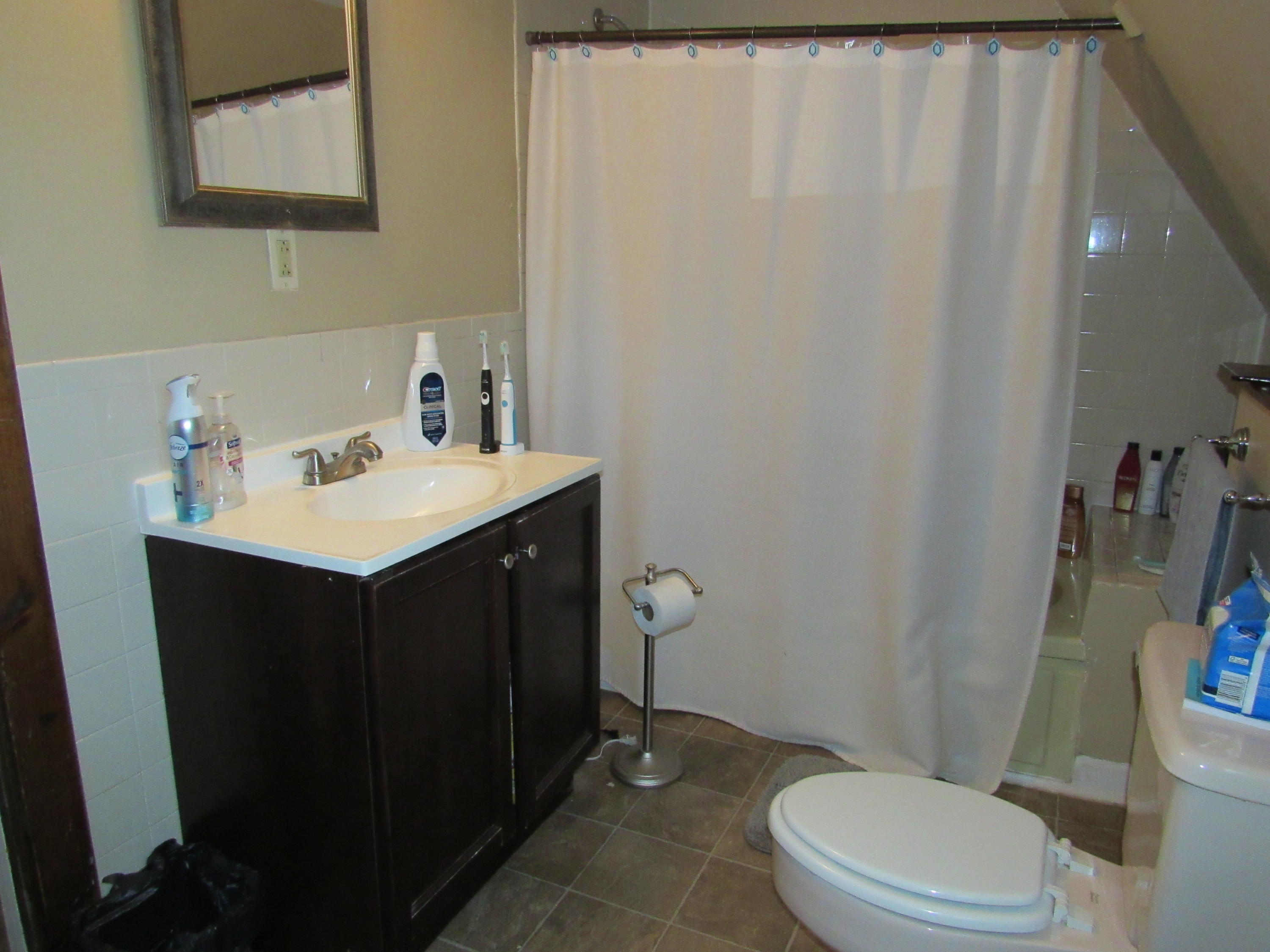 69 Nightingale Road Buzzards Bay, MA 02532 - Photo 8 of 21 a bathroom with a sink a toilet a mirror and shower curtain