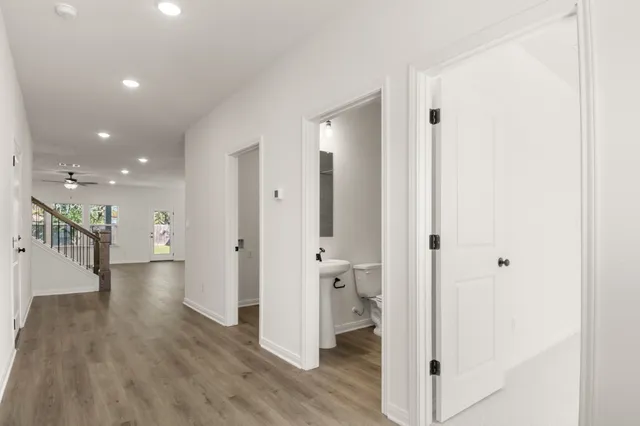 a view of a hallway with wooden floor