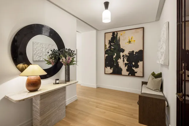 a view of a living room with a potted plant and a large window