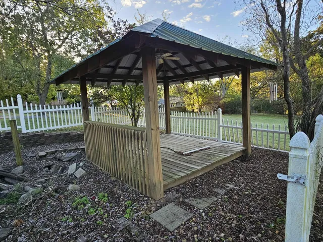 a view of a wooden deck with a small yard