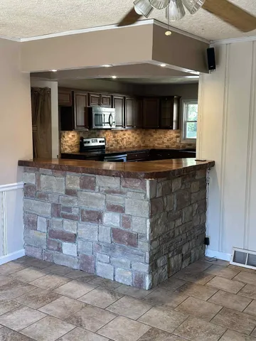 a living room with fireplace and furniture