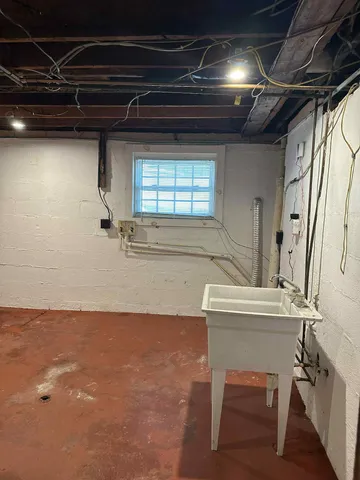 a view of a house with a yard and potted plants