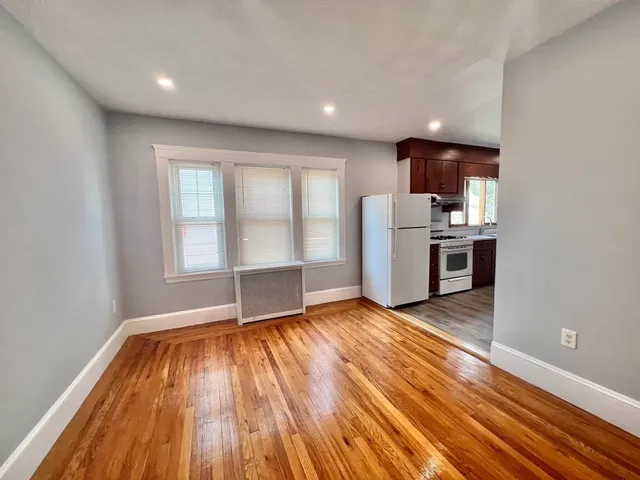 a view of a kitchen with wooden floor and electronic appliances