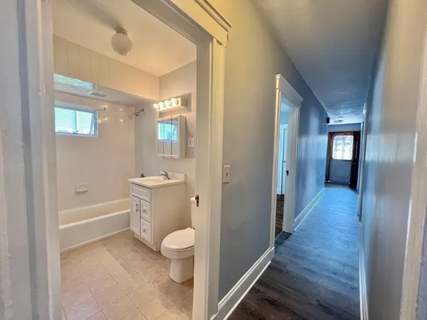 a bathroom with a toilet a sink and bathtub