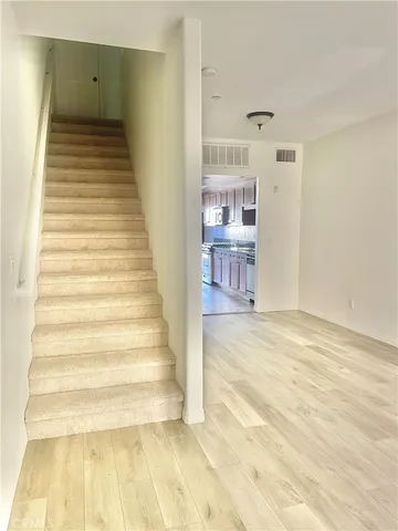 a view of a room with wooden floor and entryway