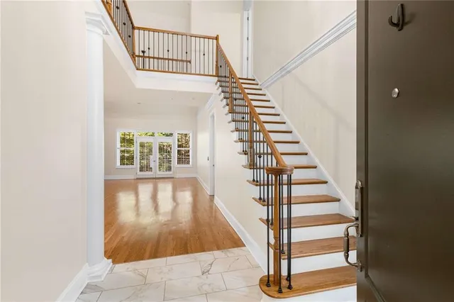 a view of empty room with wooden floor and fireplace