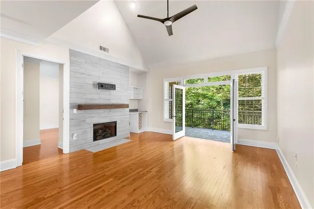 wooden floor in an empty room with a kitchen