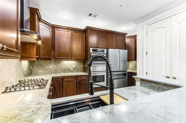 a bathroom with a granite countertop double vanity sink and mirror
