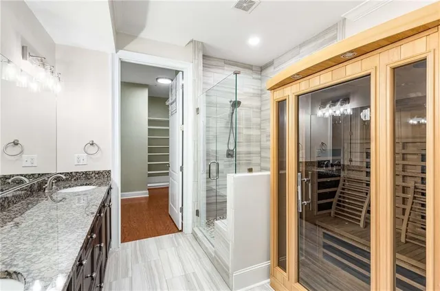 a view of an empty room with wooden floor and closet