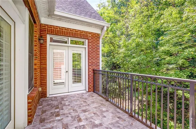 a view of a hallway with wooden floor and furniture