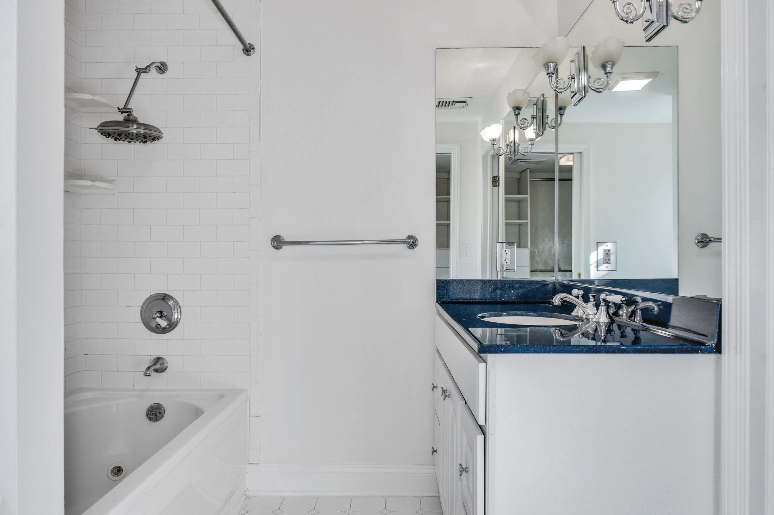 622 High Ridge Road Stamford, CT 06905 - Photo 12 of 19 a bathroom with a granite countertop sink a mirror and shower