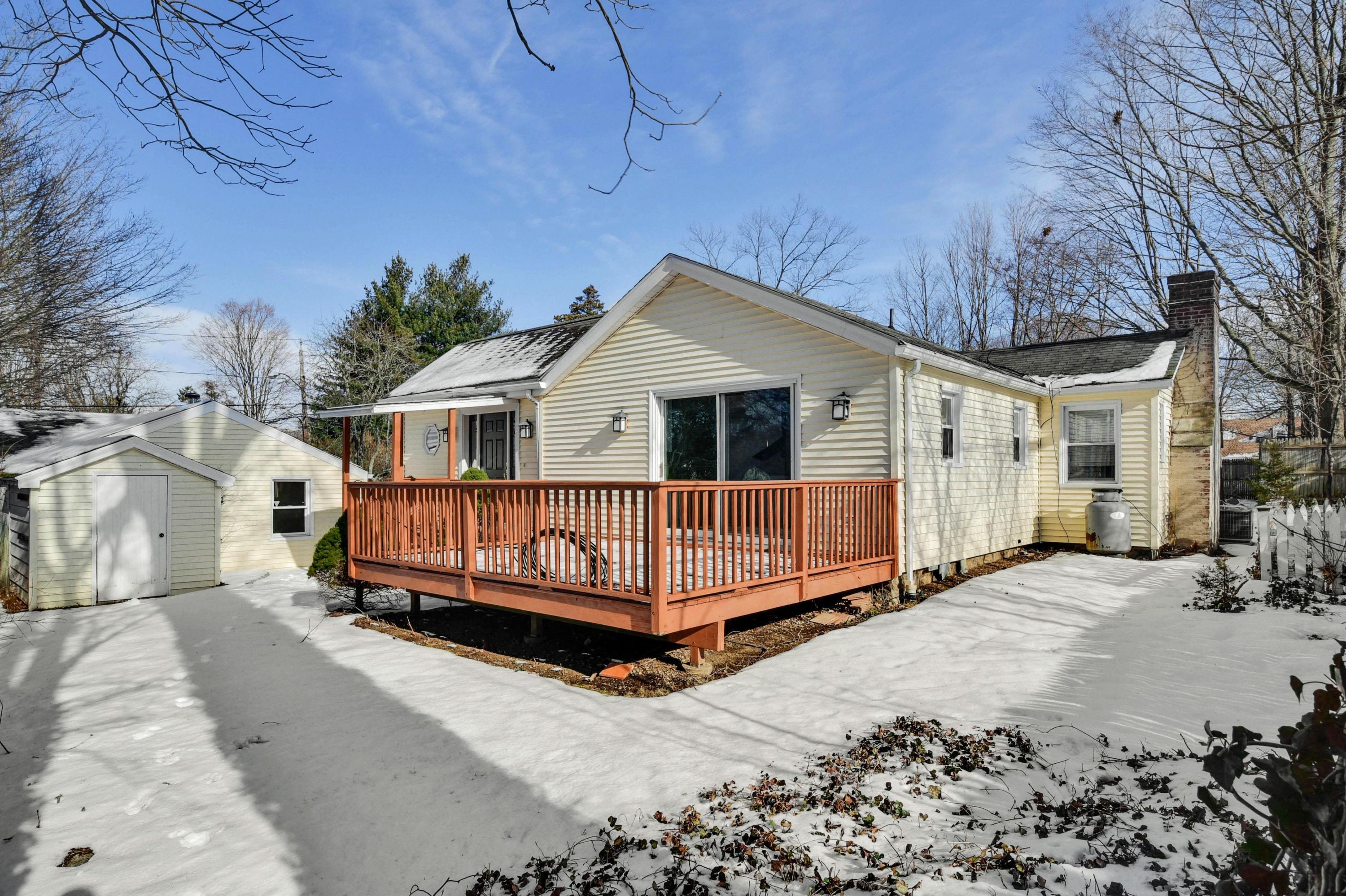 622 High Ridge Road Stamford, CT 06905 - Photo 17 of 19 a front view of a house with a yard covered in snow