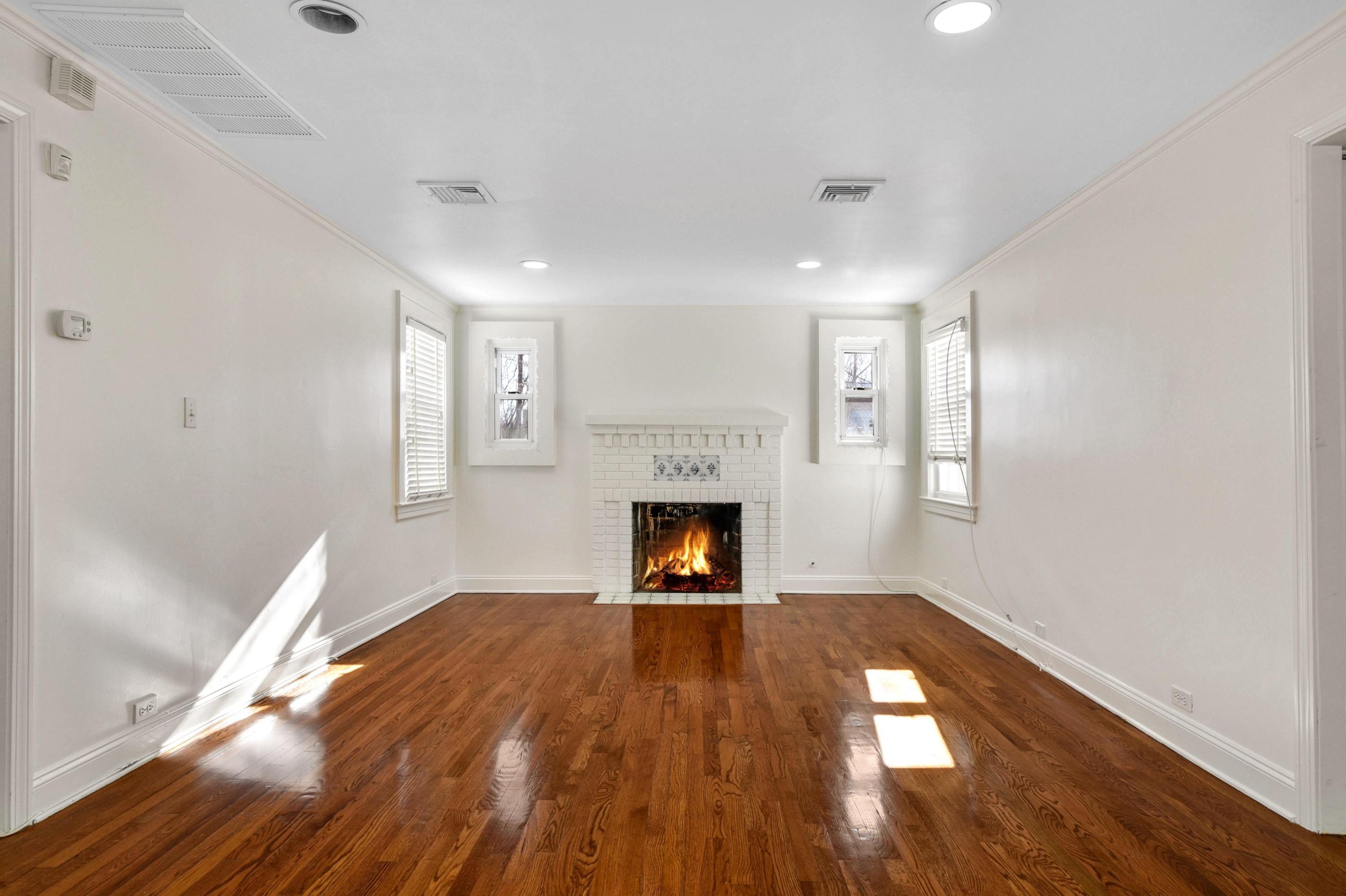 622 High Ridge Road Stamford, CT 06905 - Photo 9 of 19 a view of empty room with wooden floor and fireplace