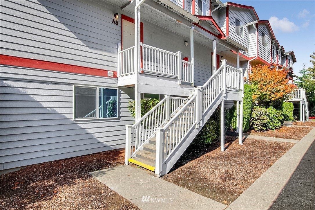 3939 10th Street Southeast, Unit A2 Puyallup, WA 98374 - Photo 2 of 27 a view of a house with a small yard and wooden floor and fence