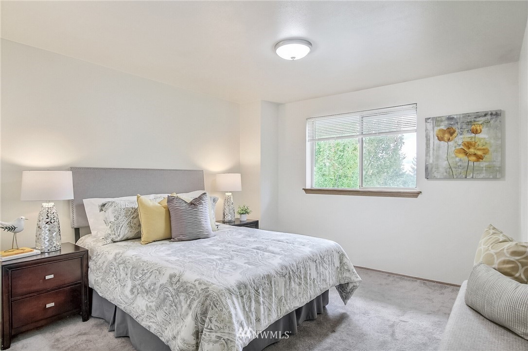 3939 10th Street Southeast, Unit A2 Puyallup, WA 98374 - Photo 19 of 27 a bedroom with a bed and wall painting