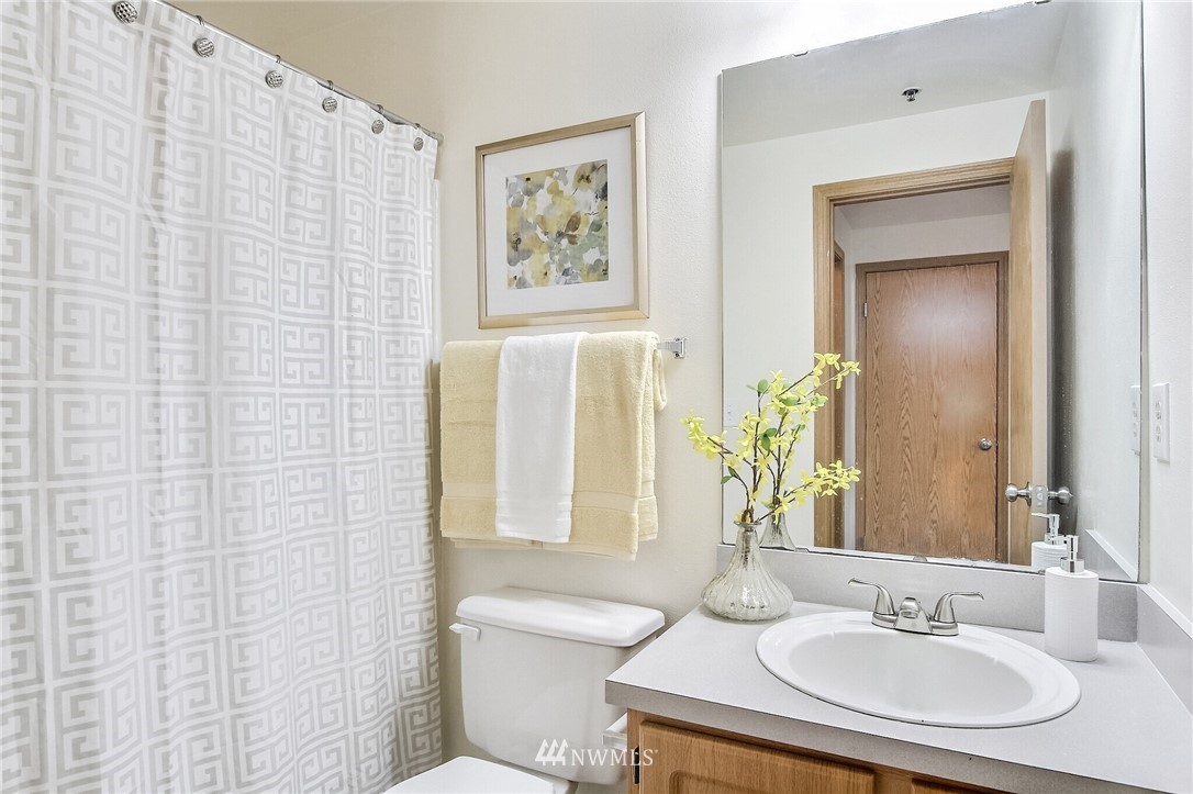 3939 10th Street Southeast, Unit A2 Puyallup, WA 98374 - Photo 22 of 27 a bathroom with a granite countertop sink and a mirror