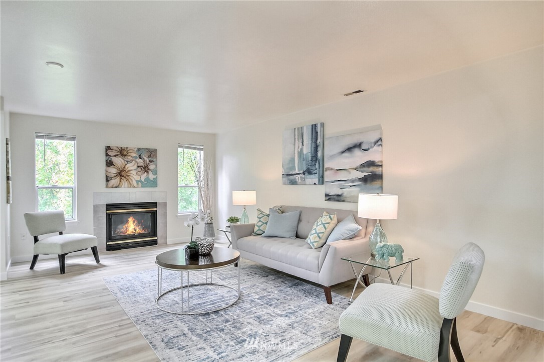 3939 10th Street Southeast, Unit A2 Puyallup, WA 98374 - Photo 6 of 27 a living room with furniture a fireplace and a large window