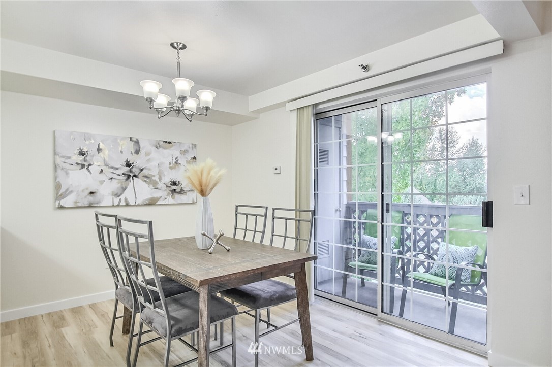 3939 10th Street Southeast, Unit A2 Puyallup, WA 98374 - Photo 8 of 27 a view of a dining room with furniture wooden floor and a chandelier