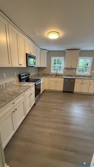 1424 Decatur Street Richmond, VA 23224 - Photo 4 of 30 a large kitchen with cabinets wooden floor and stainless steel appliances