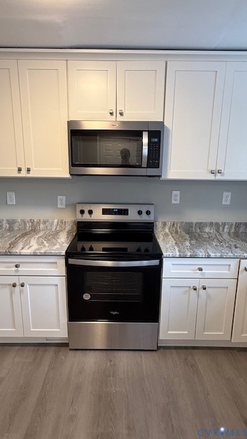 1424 Decatur Street Richmond, VA 23224 - Photo 10 of 30 a kitchen with stainless steel appliances granite countertop a stove a sink and white cabinets