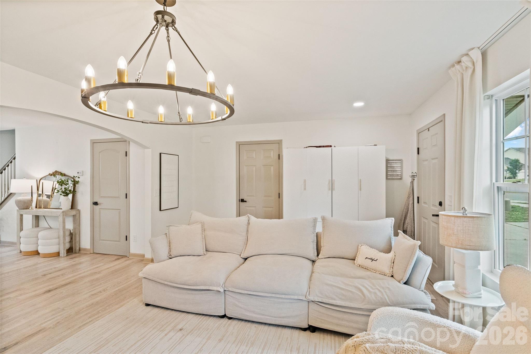 8726 Conrad Street Locust, NC 28097 - Photo 6 of 36 a living room with furniture and a chandelier